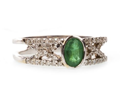 GREEN GEM AND DIAMOND RING, set with a central oval green gem flanked by diamond set X motifs, to a bifurcated shank, in eigh