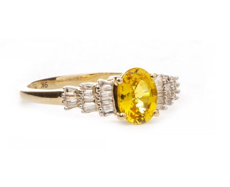 YELLOW SAPPHIRE AND DIAMOND RING, set with a central oval faceted yellow sapphire 7mm long flanked by taper cut diamonds, mar