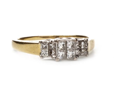 DIAMOND DRESS RING, formed by three sections each set with four princess cut diamonds, the diamonds totalling approximately 0