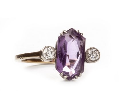 PURPLE GEM AND DIAMOND RING, early twentieth century, set with a central hexagonal mixed cut purple gem flanked by two old ro