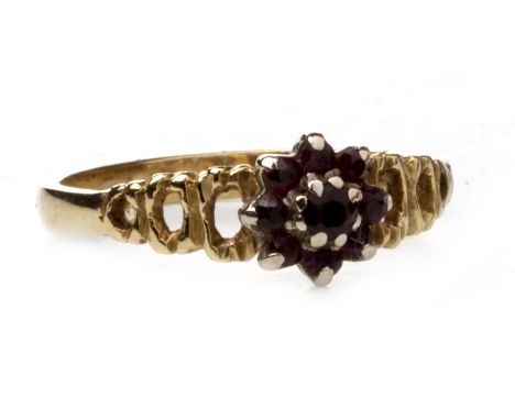 RED GEM SET RING, in the form of a flower cluster, on openwork shoulders, marked 18ct, size S, 3.5g