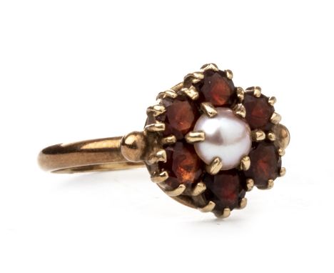 RED GEM SET AND PEARL RING, set with a central split pearl 5mm diameter surrounded by round faceted red gems, marked 9CT, siz