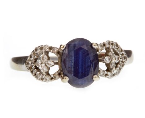 BLUE GEM AND DIAMOND RING, the central oval faceted blue gem 7mm long, on openwork diamond shoulders, the diamonds totalling 