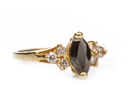 BLACK AND WHITE GEM SET RING, set with a central marquise shaped faceted black gem, flanked by two groups of three white gems