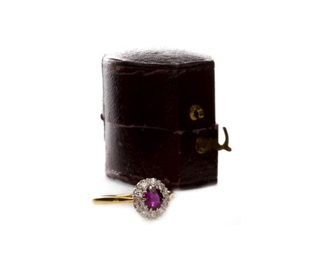 RED GEM AND DIAMOND SET RING, early twentieth century, set with a central oval red gem surrounded by round diamonds, marked 1