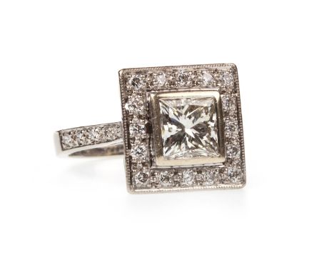 AN ART DECO STYLE DIAMOND DRESS RING, set with a central princess cut diamond of approximately 1.10 carats with accompanying 