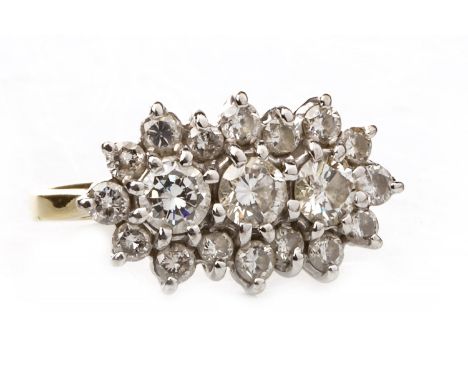 DIAMOND CLUSTER RING, set with three central round brilliant cut diamonds totalling approximately 0.60 carats within a diamon