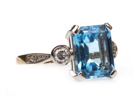 BLUE GEM AND DIAMOND RING, the central step cut blue gem 10mm long and flanked by two round brilliant cut diamonds of approxi