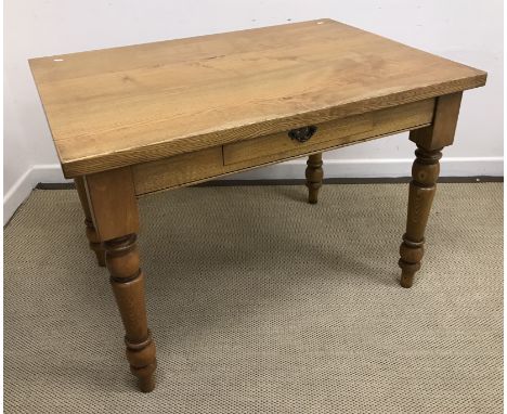 A Stuart Linford oak dining table, the plain top over a single frieze drawer on turned tapering legs in the Victorian manner,