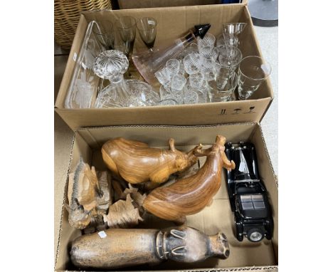 Two boxes of assorted sundry household items to include various treenware animals, a model Bugatti and a box of assorted glas