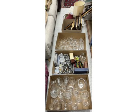 Three boxes of assorted china and glassware to include various wine glasses, jugs etc, and a box containing four brass table 