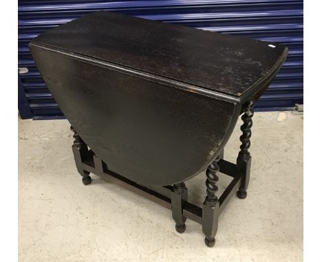 An early 20th Century stained oak oval gate leg drop leaf dining table on barley twist supports in the 18th Century manner, 9