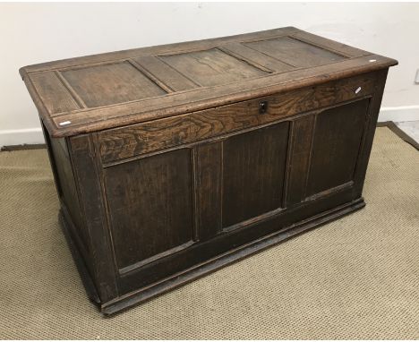 A 19th Century oak and elm coffer, the three panel top over a three panel front interspersed by moulded stiles on a shallow p