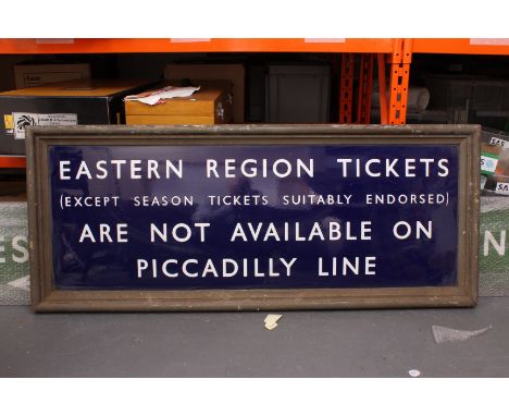 An Eastern Region Tickets not available on Piccadilly Line Sign, in royal blue enamel with wood surround, VG, grubby