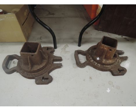 A pair of vintage cast iron championship tennis post holders