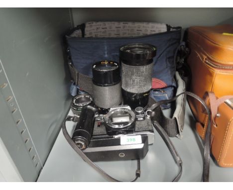 An Olympus OM 10, Hanimex Macra Focusing zoom, Mitakon zoom, in soft camera bag