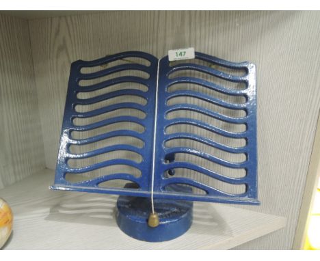 A vintage metal cast recipe or book stand
