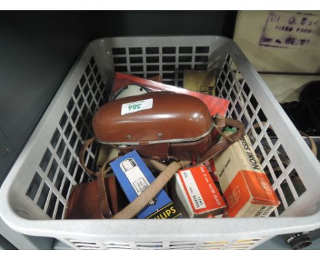 A box of photography equipment including a Voigtlander Vito C camera, Zeiss Ikon light meter, flash guns, bulbs etc