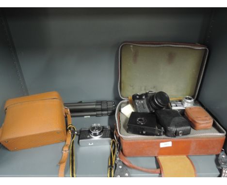 A selection of cameras including an Olympus Trip 35 in leather case,  Zenit II , a Ricoh Caddy etc and a Culman tripod