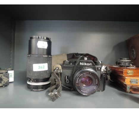 A Nikon EM camera and and additional Series E telephoto lens