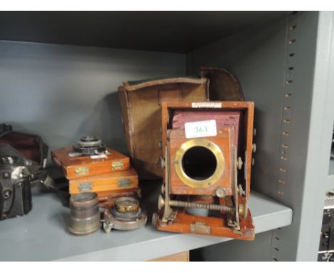A Victorian mahogany cased field camera marked J Lancaster & Son, Birmingham with plates and various lenses and shutters in o