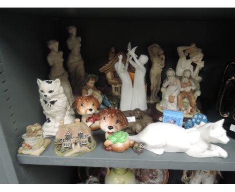 A selection of vintage figures and figurines including cats