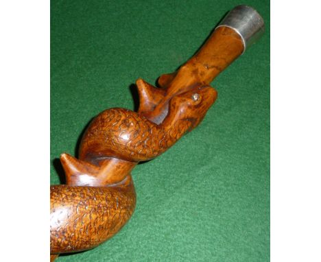 An Australian carved wood walking stick with entwined snake and silver top