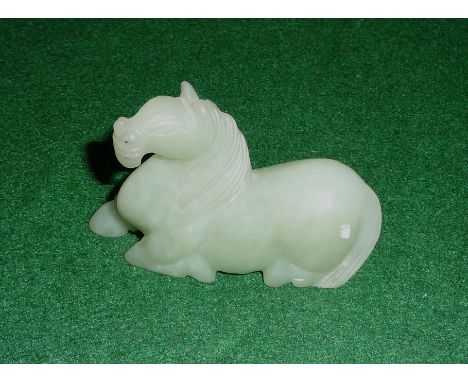 A small carved jade horse
