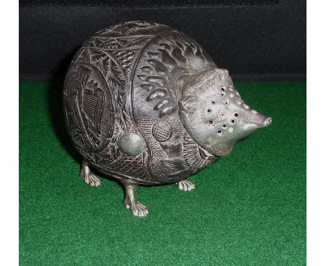 A carved coconut shell silver mounted desk sander modelled as a hedgehog