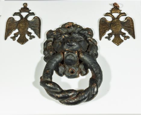 A Georgian cast iron lion door knocker with two Russian eagle pendants