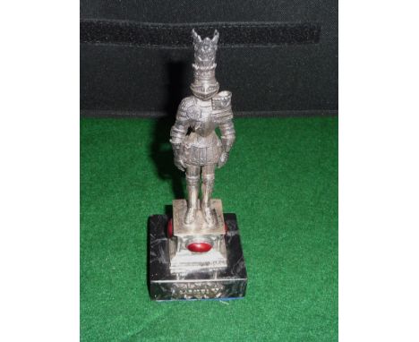 A silver knight with enamel cabouchons on a marble base