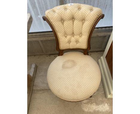 A VICTORIAN WALNUT BUTTON-BACK NURSING CHAIR ON TURNED AND FLUTED LEGS 