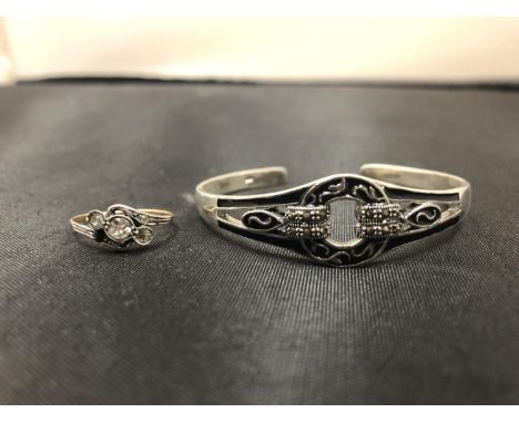 A SILVER BANGLE AND A SILVER RING 