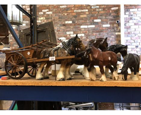 A LARGE SHIRE HORSE AND WOODEN CART WITH FOUR OTHER CERAMIC SHIRE HORSES 