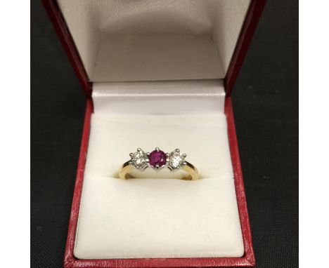 A 18CT YELLOW GOLD RING SET WITH A CENTRE RUBY AND TWO IN LINE DIAMONDS 4.2 GRAMS 