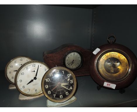 A selection of vintage alarm clocks and barometer