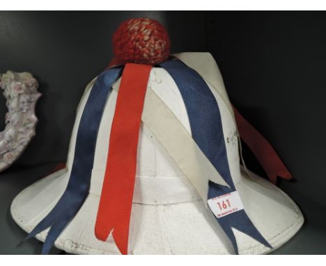 A vintage refurbished Pith helmet having English ribbon colours decoration 