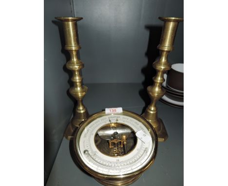 A vintage brass bodied barometer and thermometer with visible mechanism