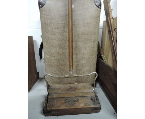 A vintage hard bodied case and early Ewbank carpet cleaner