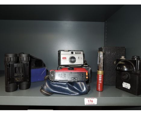 A selection of vintage viewing equipment including binoculars telescope and camera
