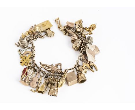 An oval linked charm bracelet, set with a quantity of charms including a cello, letter, teapot, egg timer, fish head and othe