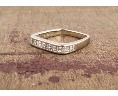 An 18ct white gold channel set square shaped dress ring, the square cuts in channel settings ring size G1/2.5g