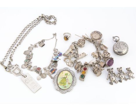 A collection of silver and white metal jewels, including a silver charm bracelet, set with various charms including a traffic