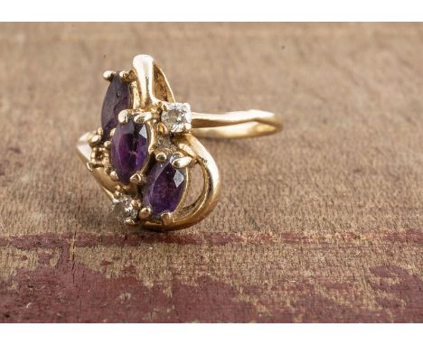 An amethyst and diamond cluster ring, oval mixed cut amethysts, and brilliants cuts, one setting vacant , ring size K 2.4g