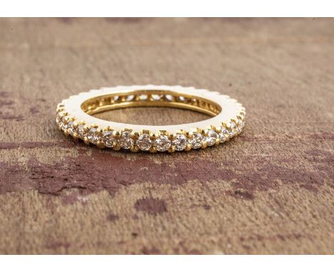 A yellow metal and diamond full eternity ring, claw set brilliant cuts, each approx 0.02cts, making a total of 0.70cts, all i