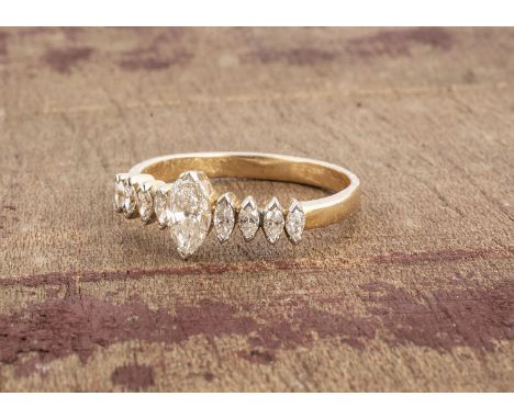 A continental yellow metal diamond set dress ring, the central marquise cut diamond flanked by four smaller examples to eithe