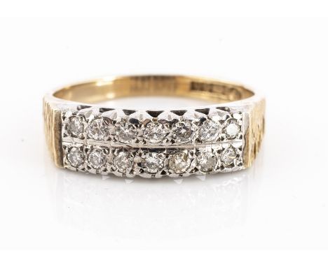 A 9ct gold double diamond band ring, two rows of brilliant cuts in a white metal gallery and setting on textured and polished