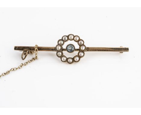 An Edwardian 15ct gold aquamarine and seed pearl bar brooch, with central wreath, half cut pearls with round cut aquamarine, 