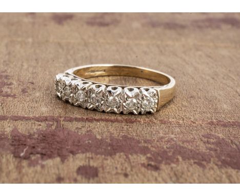 A 9ct gold diamond half hoop eternity ring, the seven brilliant cuts in illusion setting on a hallmarked yellow shank, ring s