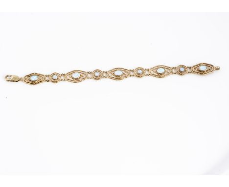 An synthetic opal and 9ct gold bracelet, of pierced design, oval links sent with oval and circular stones, 18 cm long, 11g